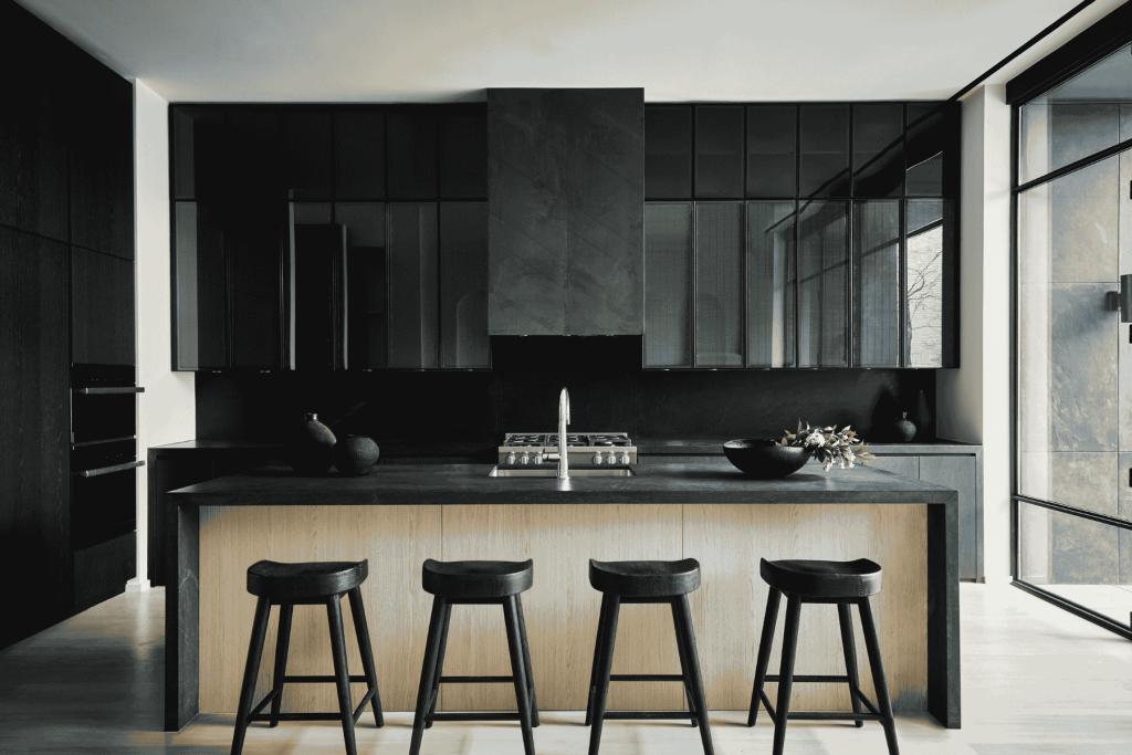 Dark cabinetry in a light-filled kitchen.