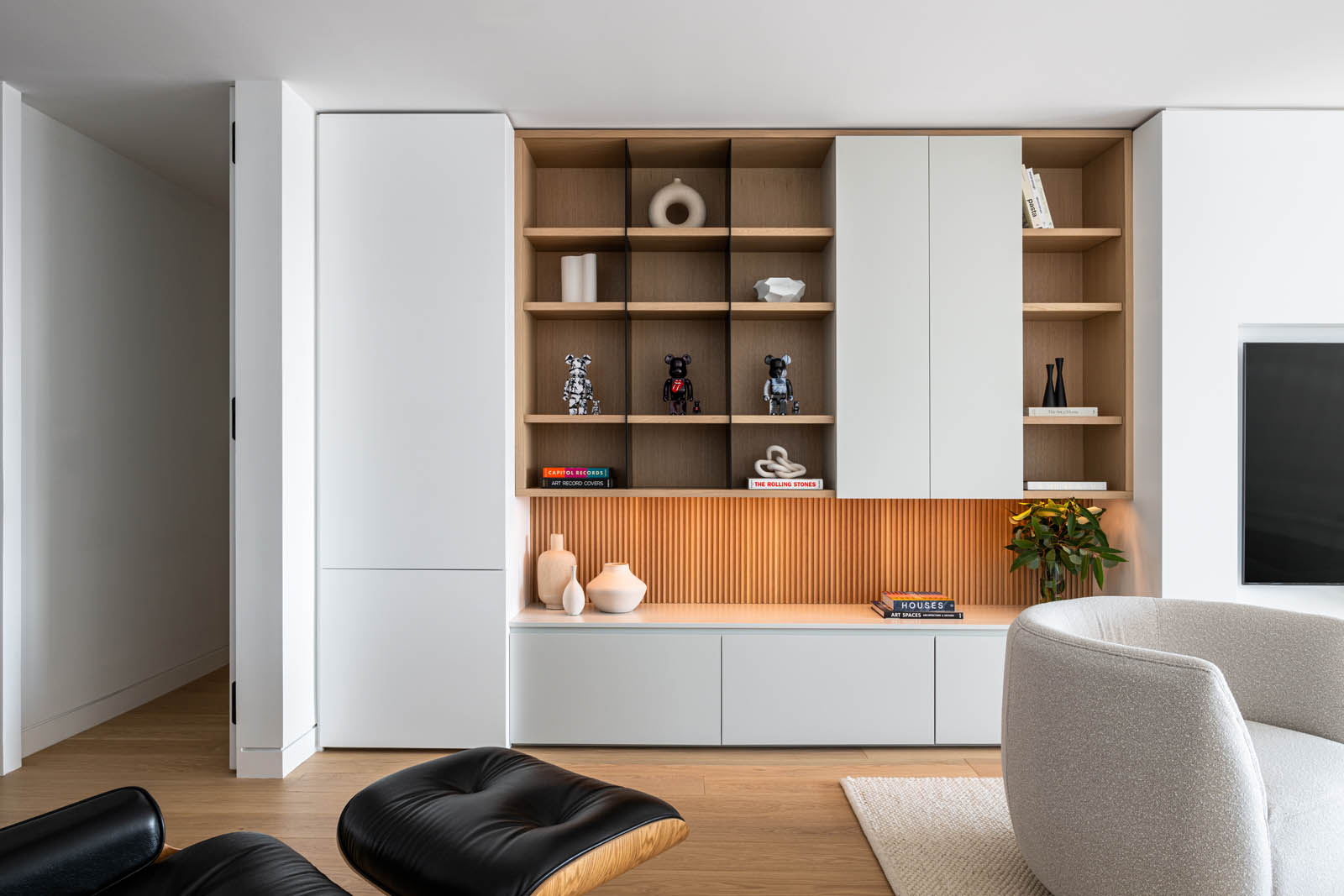 Built-in shelves with wood, lit from underneath.