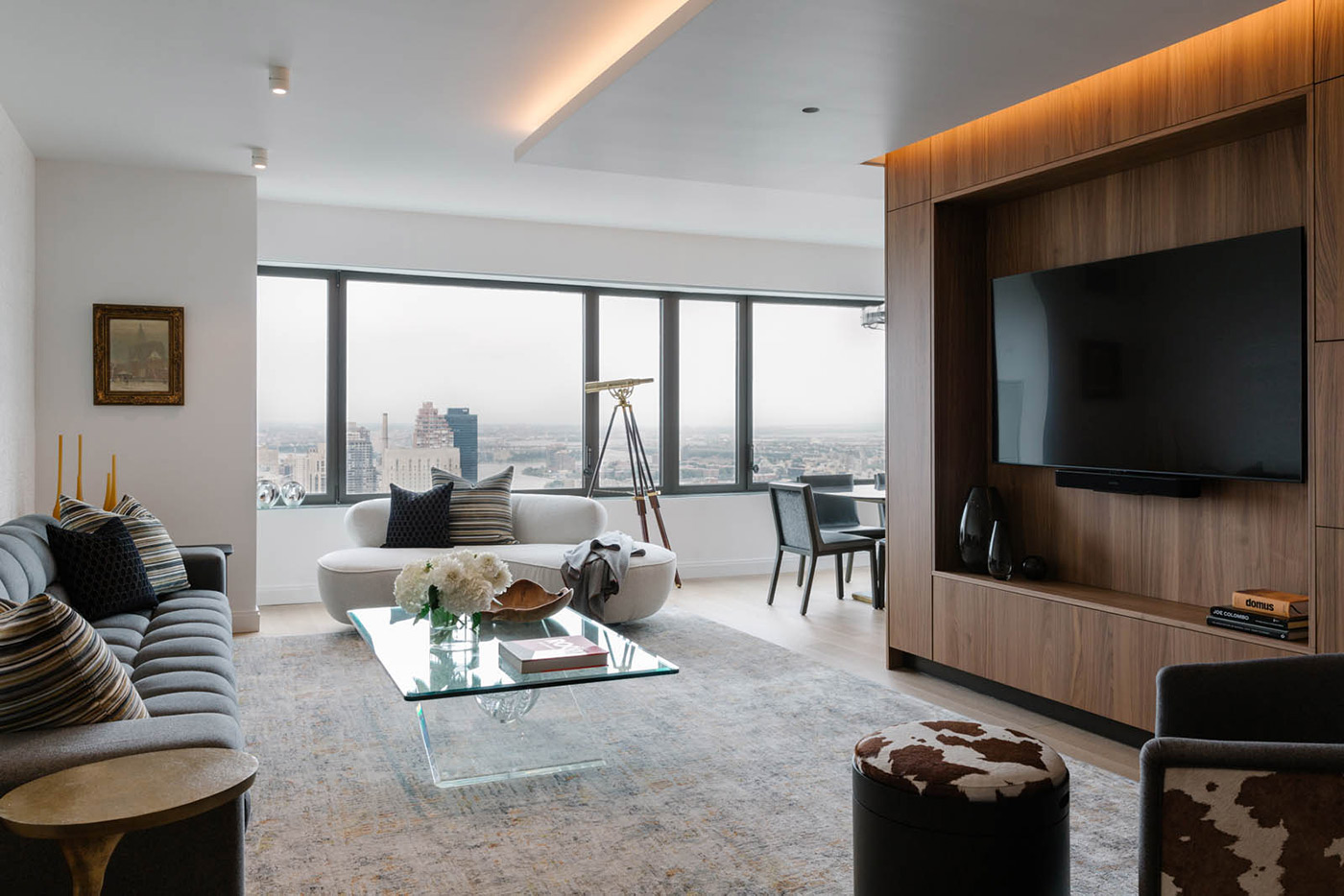 A living room with a hidden entertainment center encased in wood.