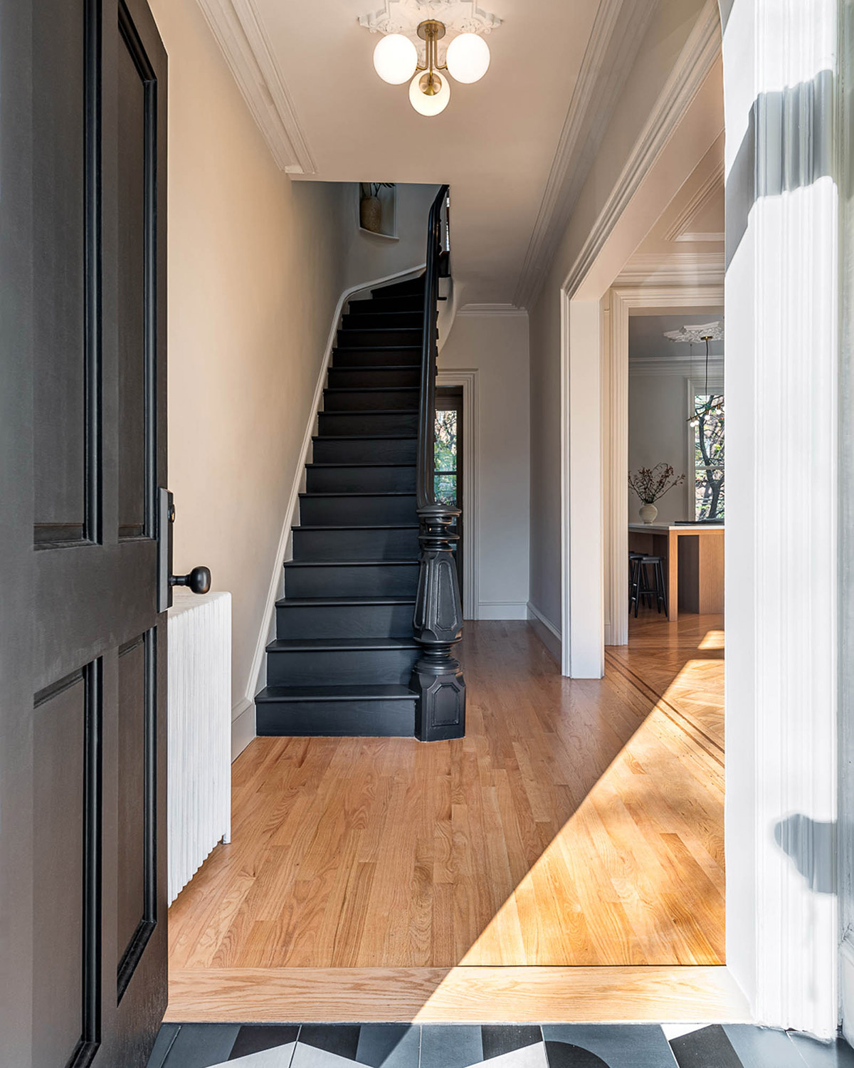 The staircase, in dark tones, is the focal point of this entry.