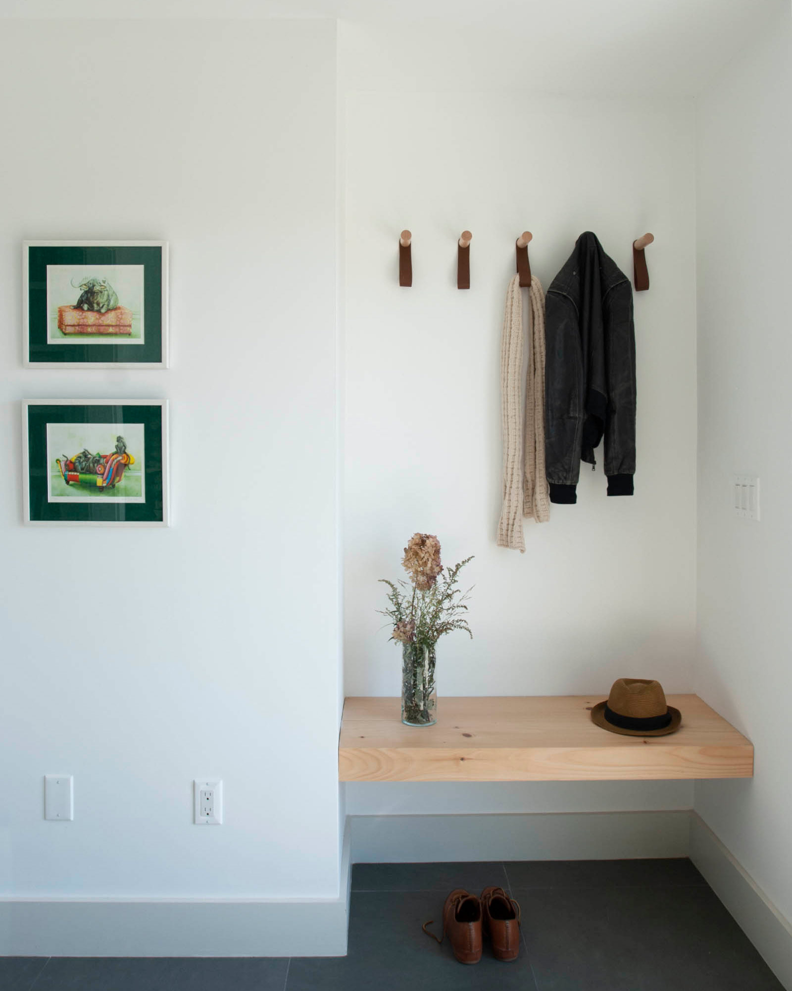 An entryway with thoughtfully designed spaces for coats and shoes.