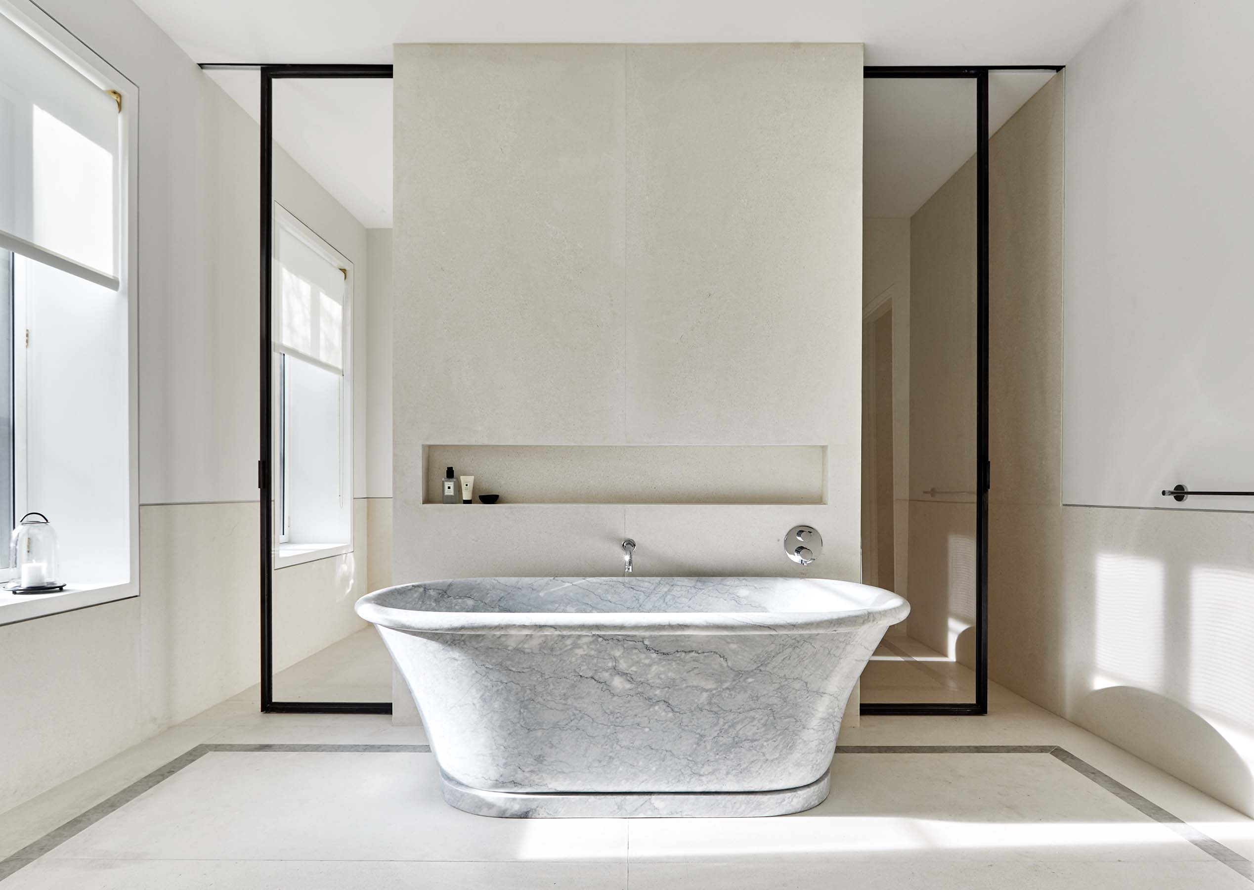 A neutral bathroom featuring a gray soaking tub.